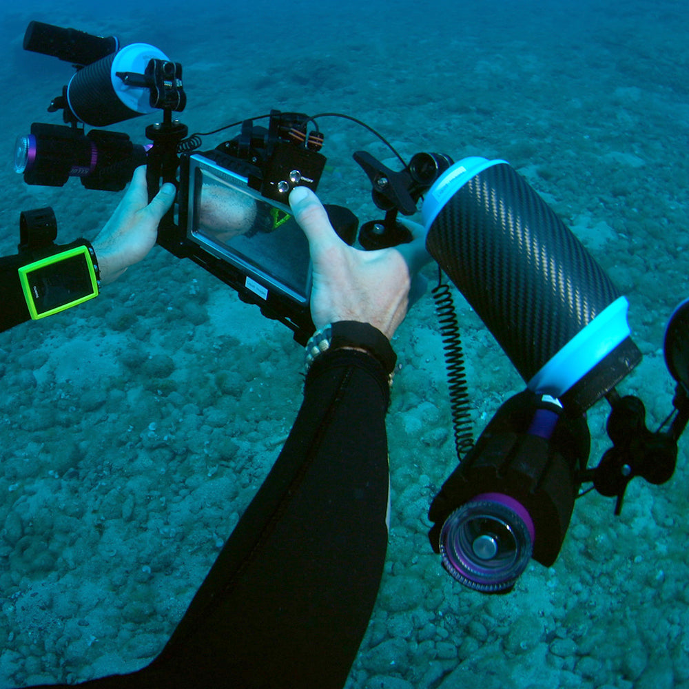 Diver using DiveVolk SL50 underwater video light remote.