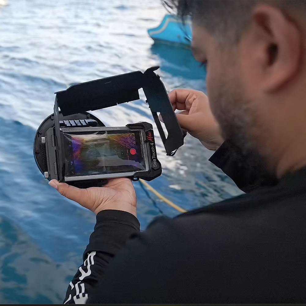 SeaTouch 4 Max housing foldable screen hood being held.