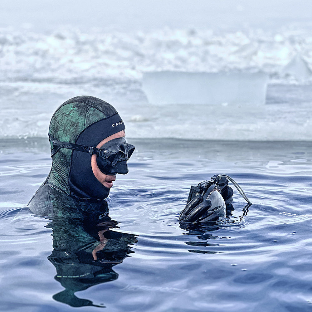 Diver with SeaTouch 4 Max dome lens housing in arctic water