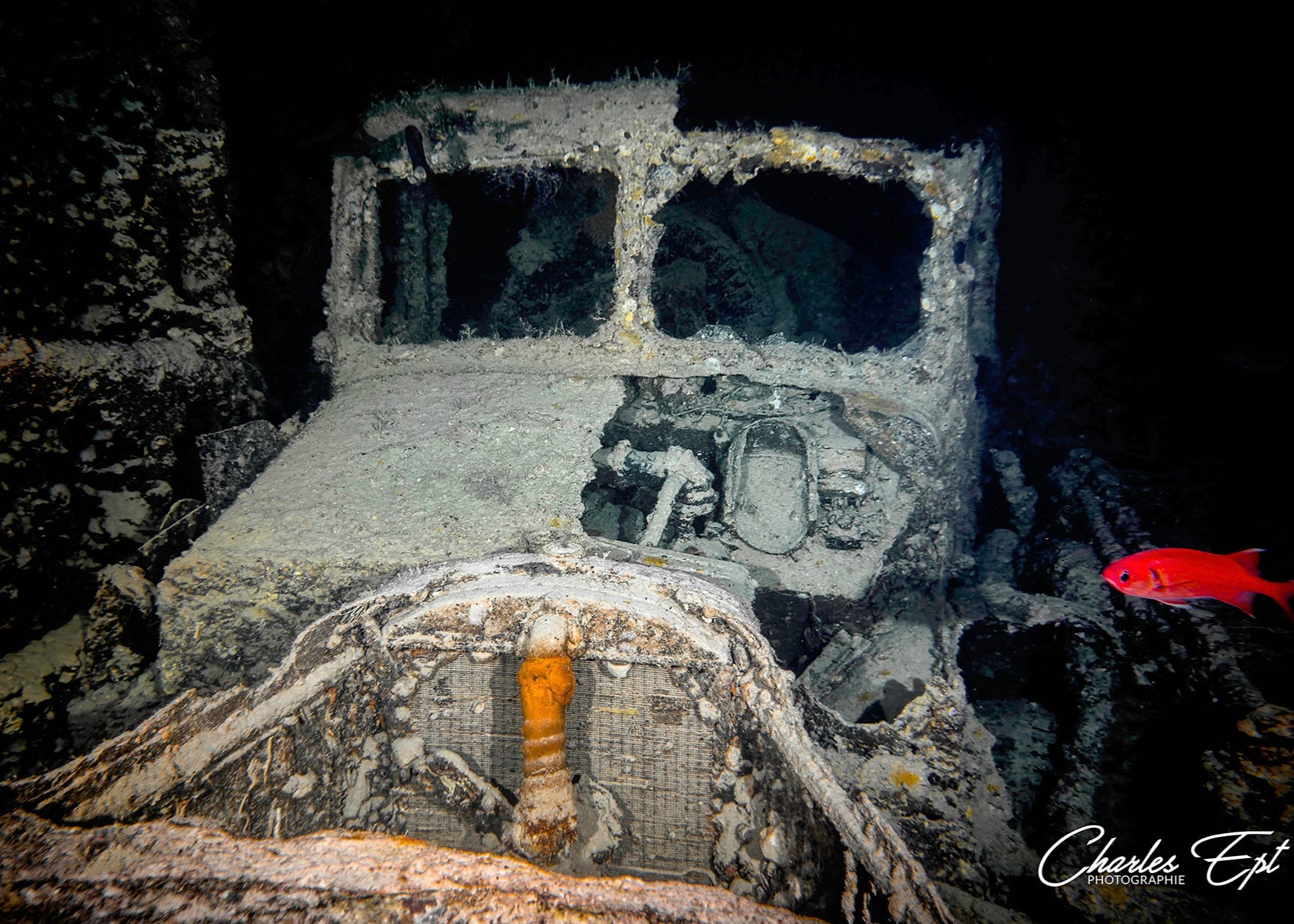 A close-up of an underwater shipwreck captured with the SeaTouch 4 Max Housing, showcasing the eroded details and coral-covered structures of this mysterious submerged relic.