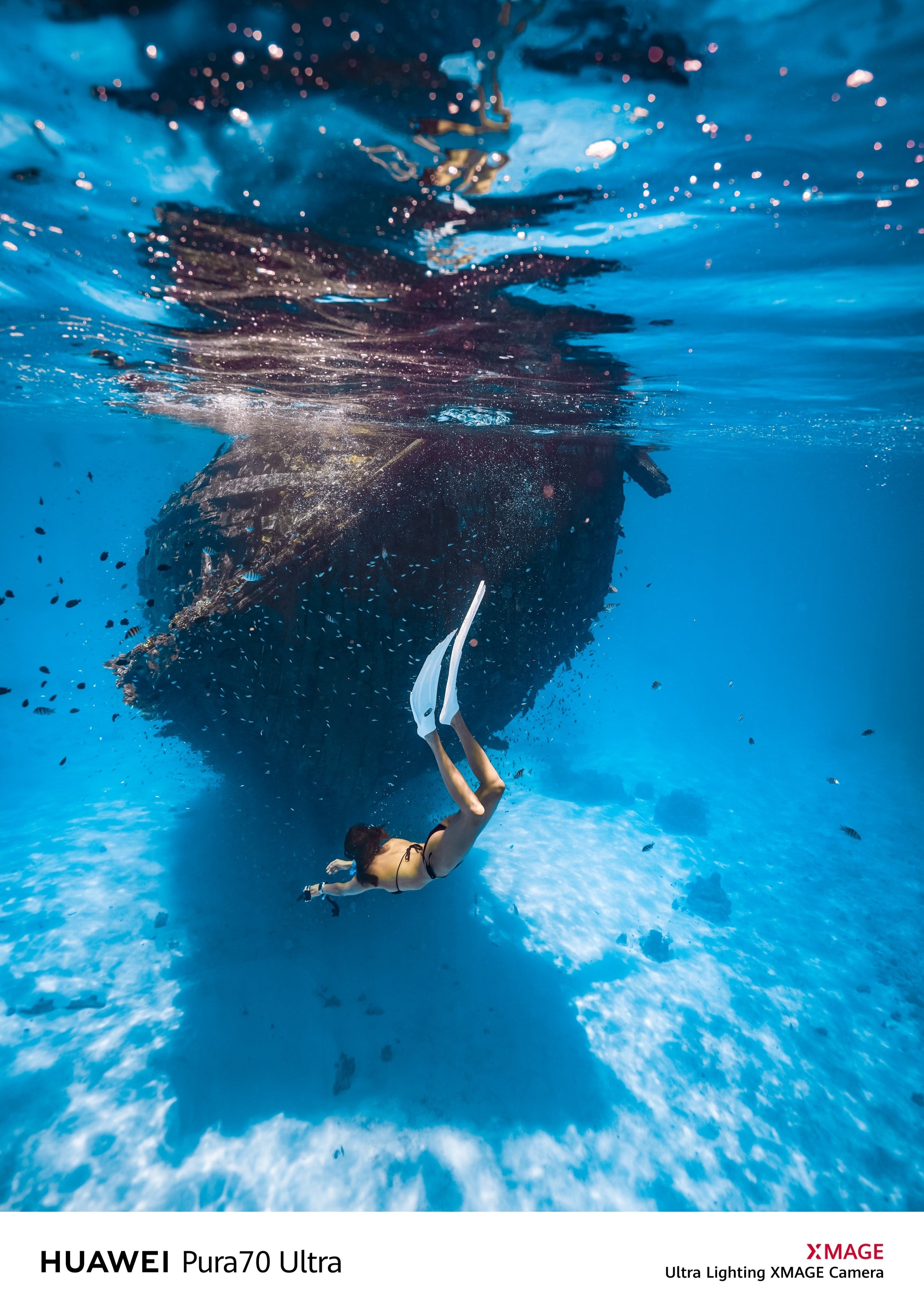 A snorkeler diving gracefully past a rocky formation underwater, captured with the SeaTouch 4 Max Plus Housing, showcasing the clarity, color vibrancy, and dynamic range of underwater photography with a focus on human subjects in natural aquatic environments.