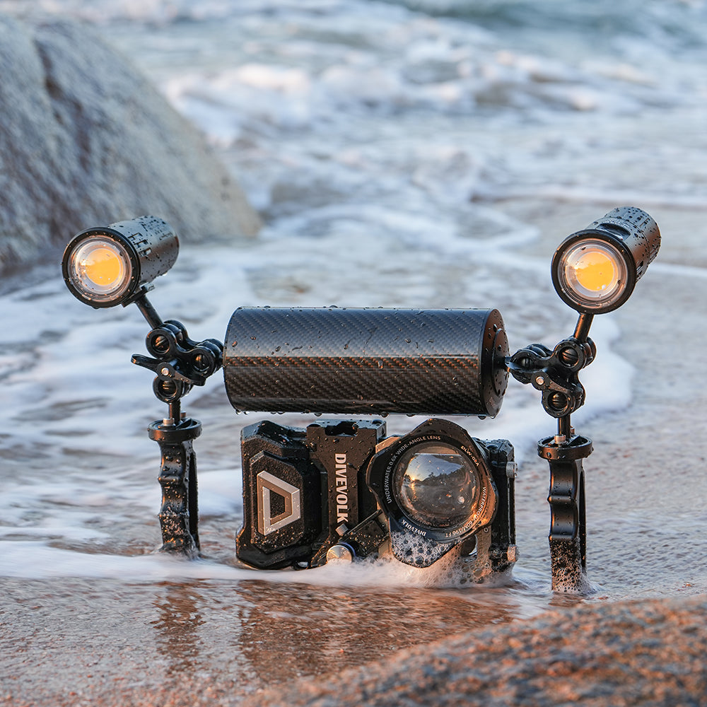 DiveVolk SeaTouch housing with float arm and underwater lights on beach.