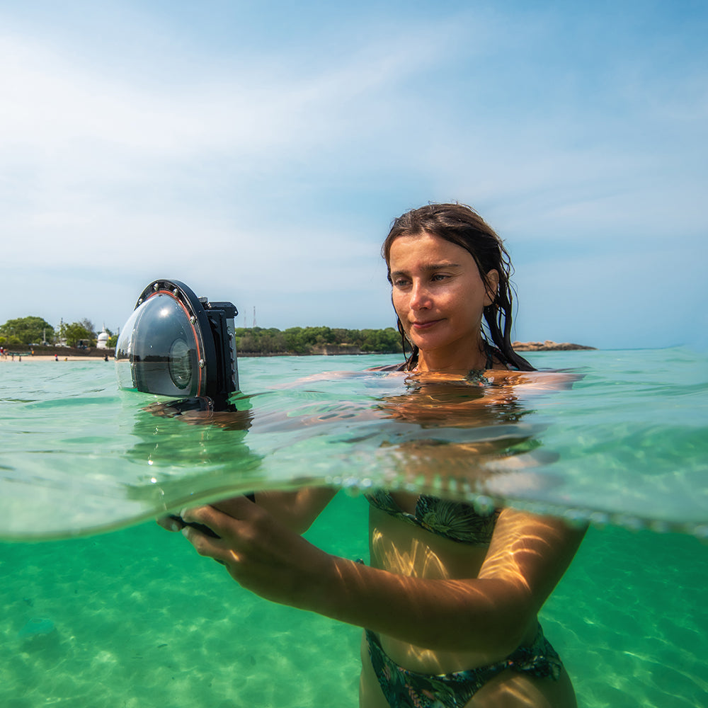 Woman diving with SeaTouch 4 Max dome lens housing