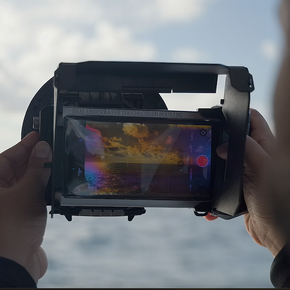 SeaTouch 4 Max housing with foldable hood in hand.