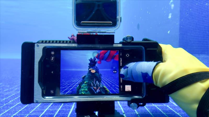 Diver using Seatouch 4 Max underwater housing and finger cot.