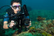 A diver is using a divevolk waterproof housing for macro photography.