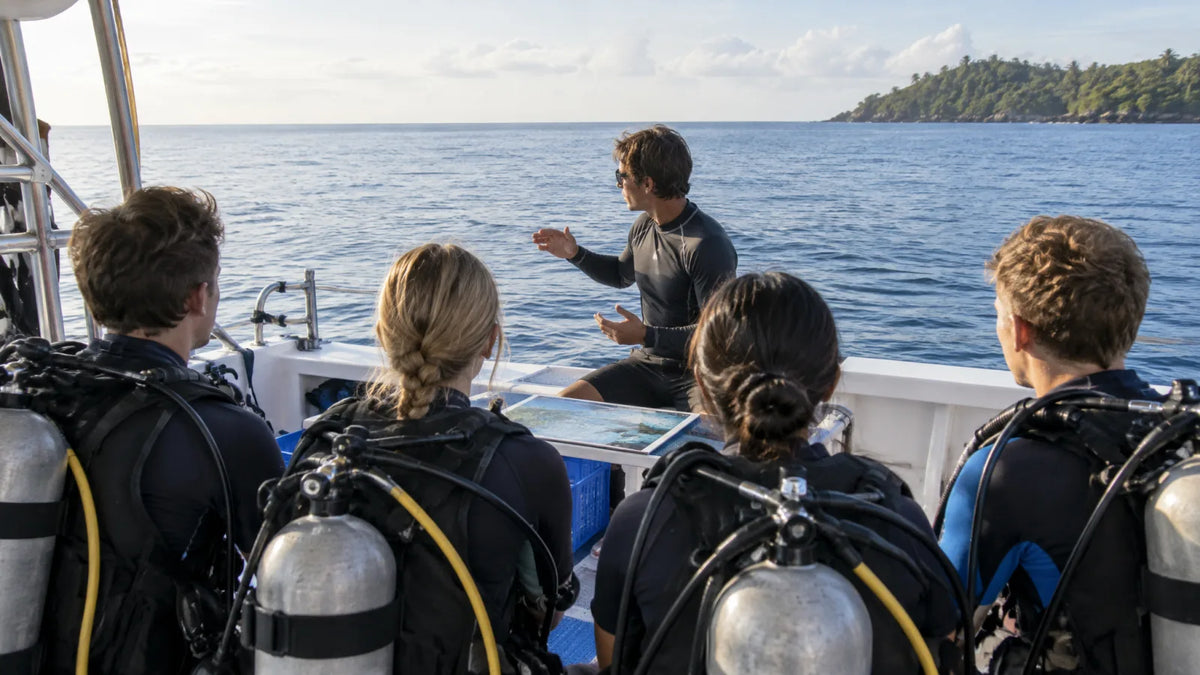 Beginner divers listening to an instructor during a briefing on a dive boat deck