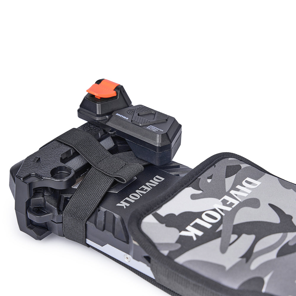 Top-down view of camouflage protective cover over SeaTouch 6 PRO housing — elastic strap secures cover while external shutter button remains fully accessible.